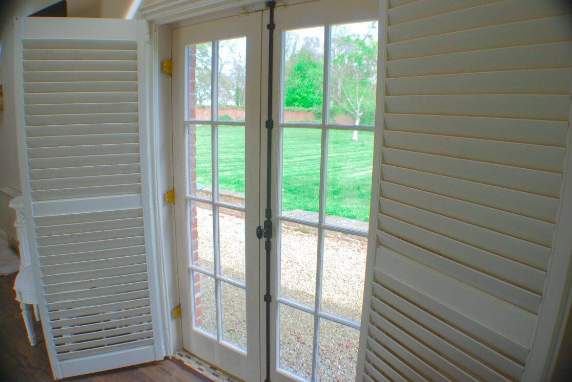 Chaumont Suite French doors with plantation shutters opening to the walled garden at Clonganny House Wexford