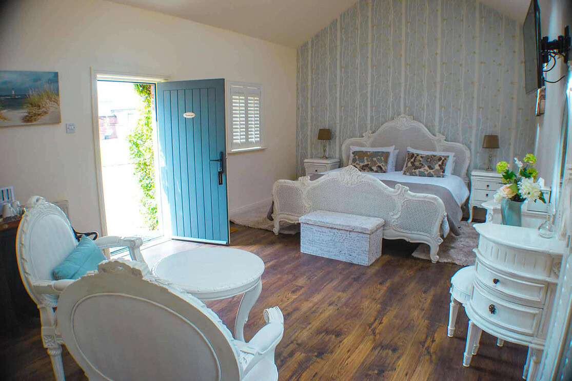 Chaumont Suite interior at Clonganny House Wexford — elegant vintage furniture and warm natural light