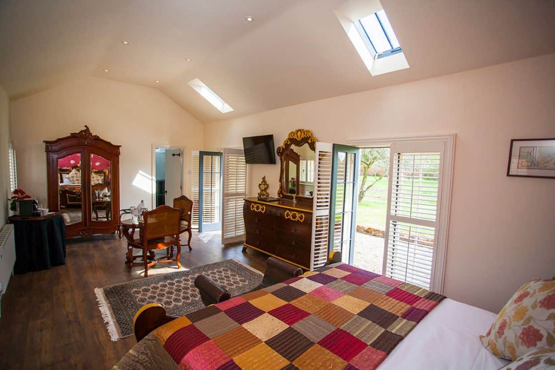 Chenonceau Suite at Clonganny House Wexford — elegant bedroom with courtyard views and private patio access