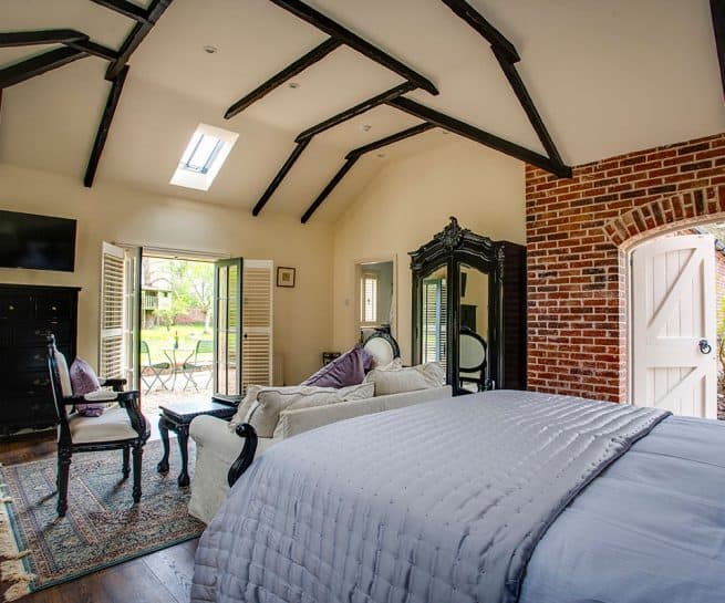 Cheverney Suite at Clonganny House Wexford — silver grey and soft purple décor with exposed brick feature wall