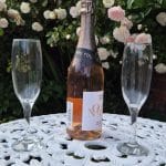 Clonganny House garden with champagne and floral backdrop.