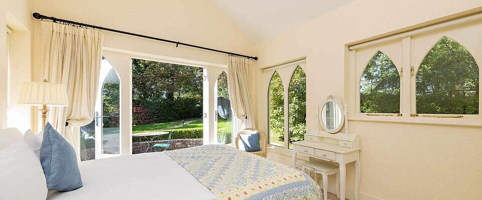 Charming Gate Lodge at Clonganny House with elegant windows and garden views.